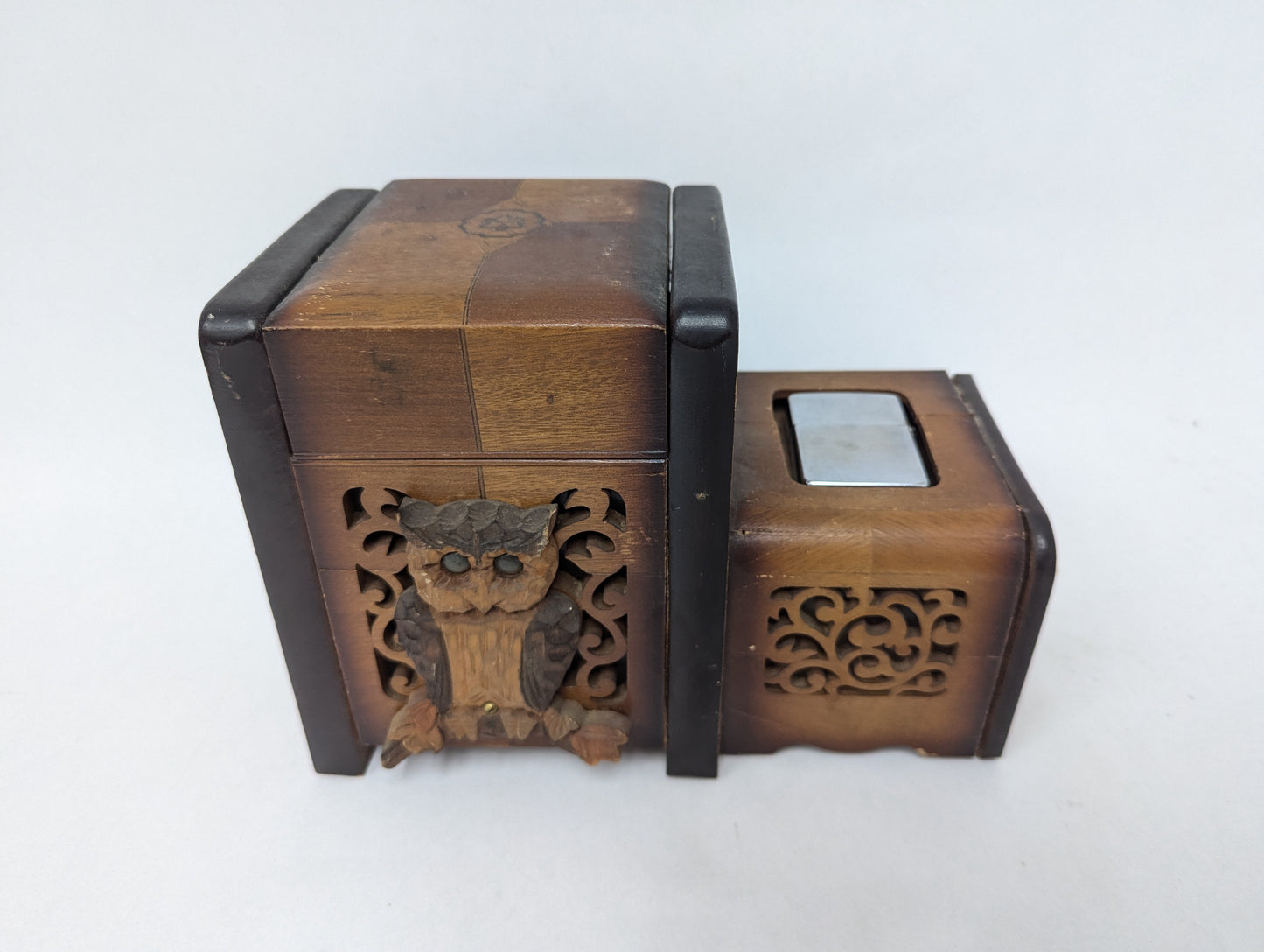 Cigarette box with owl decoration and early Zippo lighter