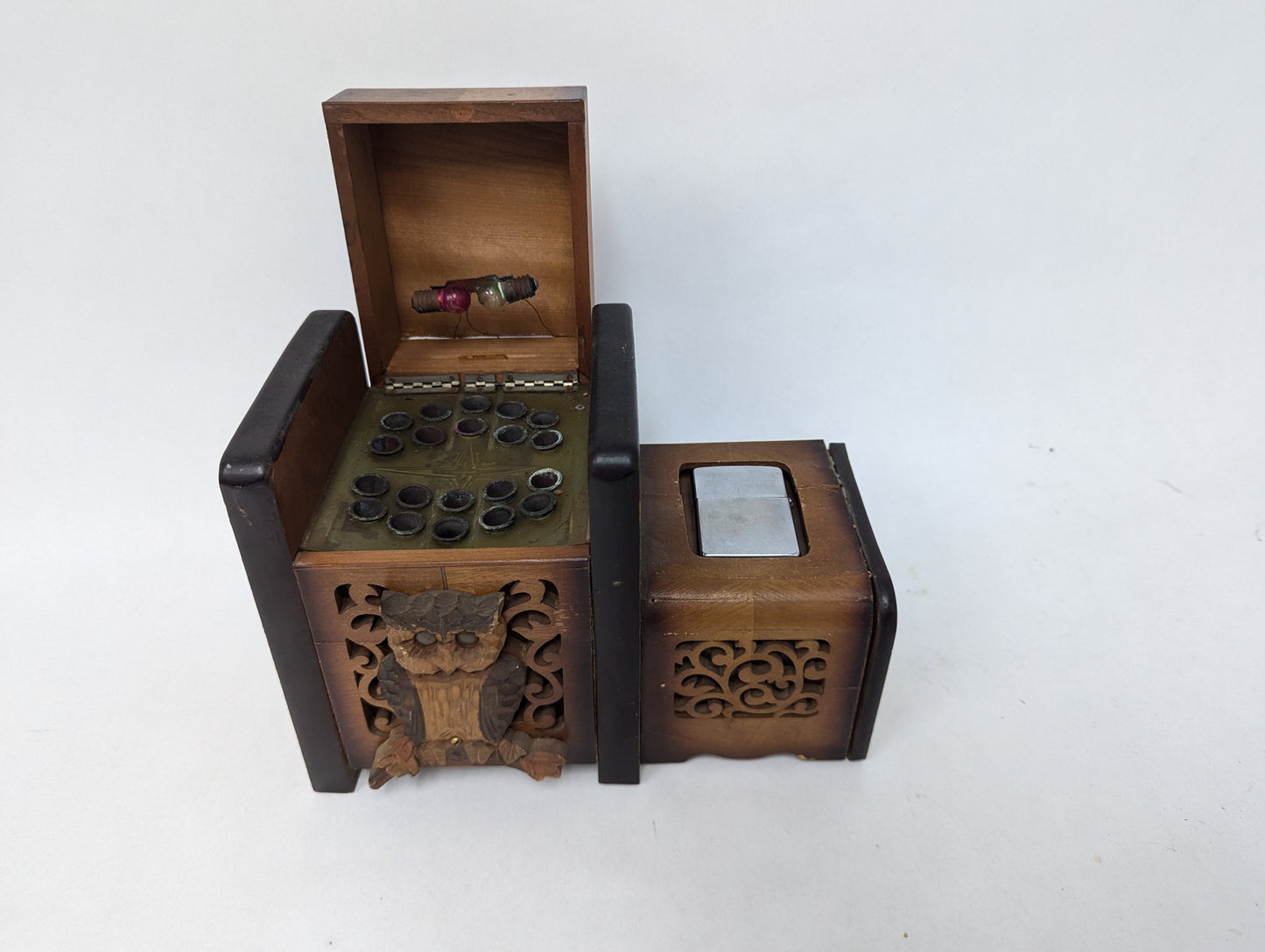 Cigarette box with owl decoration and early Zippo lighter