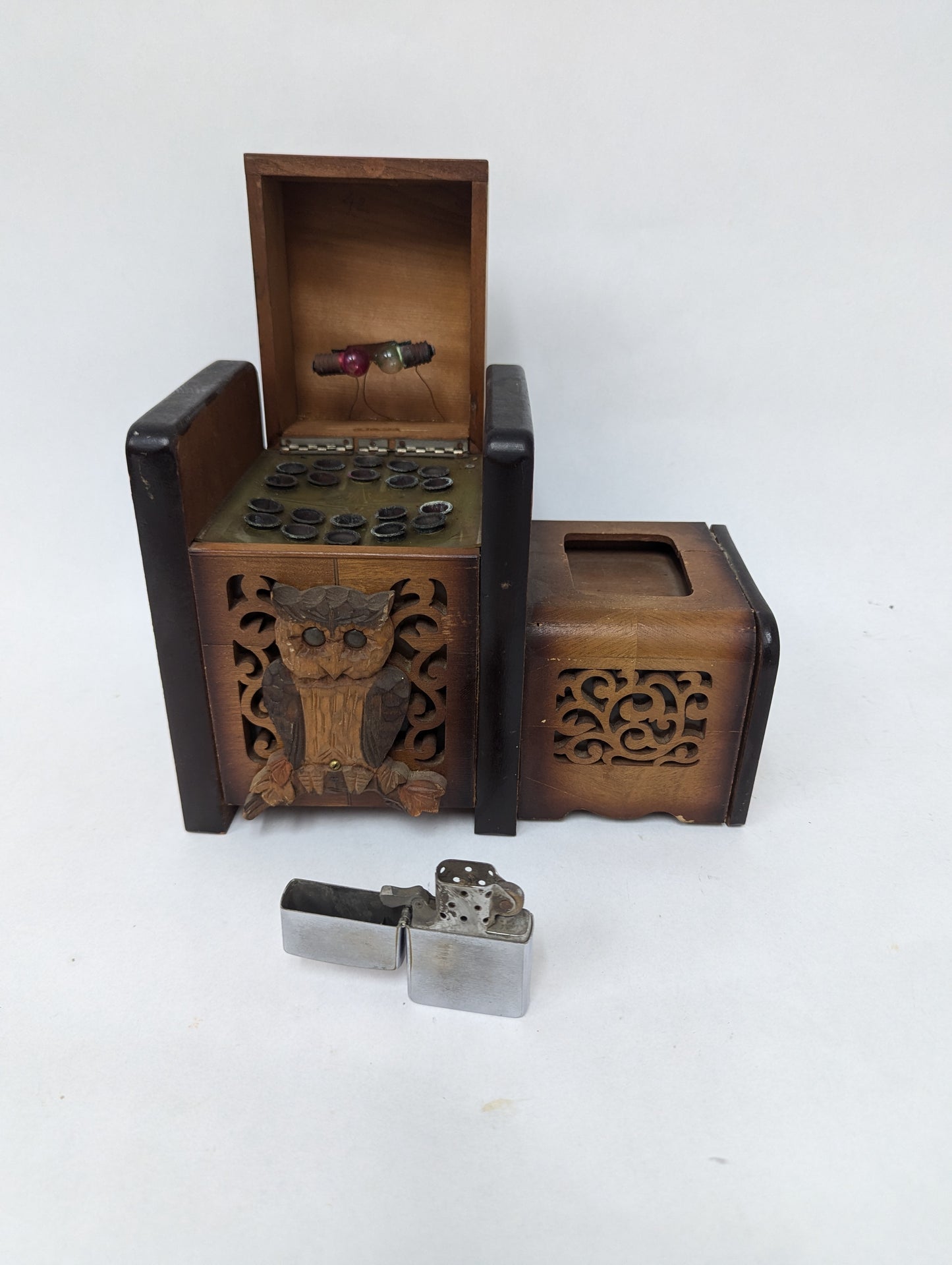 Cigarette box with owl decoration and early Zippo lighter